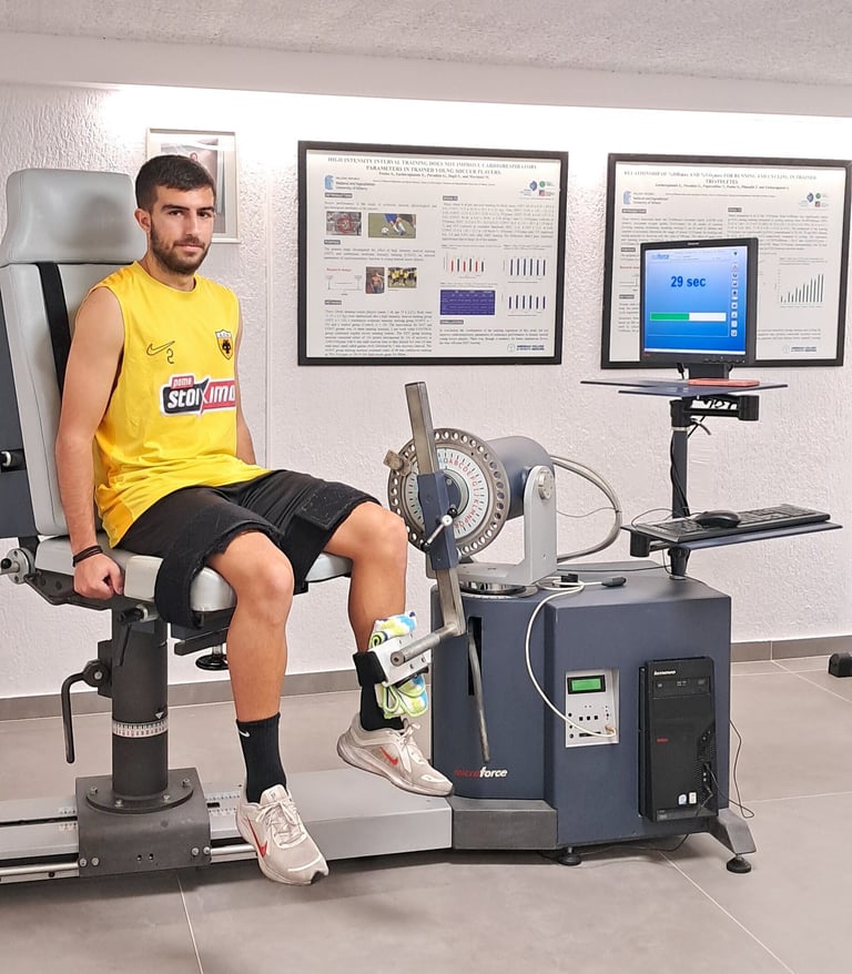 Man in yellow shirt on stationary bike with monitoring equipment